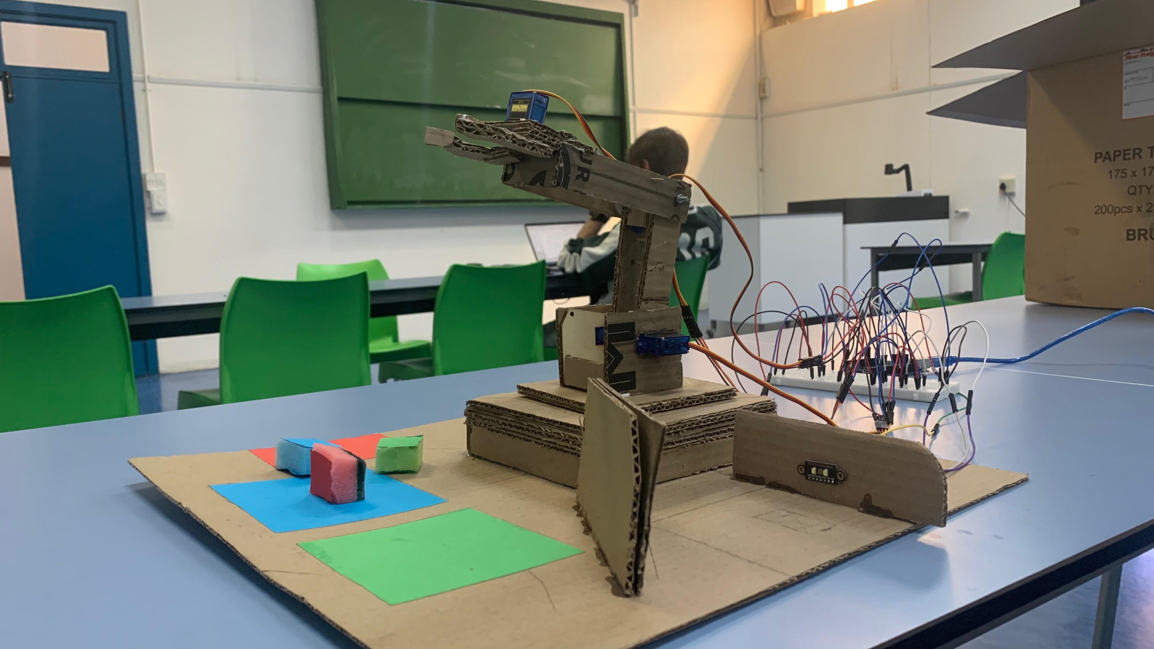 Completed RGB pick-and-place robotic arm from a three-quarter view